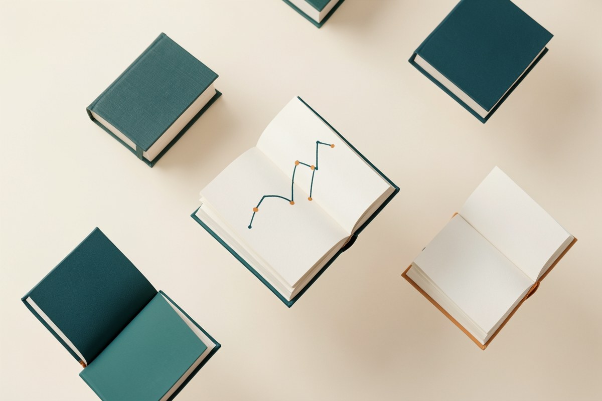 An abstract 3D render of several open books floating against a warm off-white background, with a single, visible line graph sketched on one of the pages. The color palette is